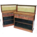 A pair of 19th century rosewood and amboyna bookcases, the superstructure having a pierced brass