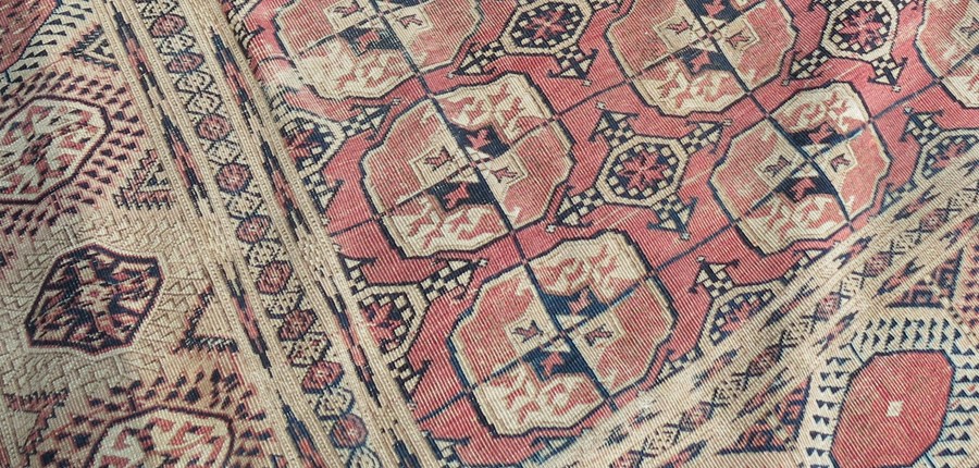 An Eastern style rug, decorated with repeating motifs to the field and hooked gulls to the - Image 2 of 4