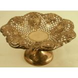 A pierced silver pedestal bowl, the bowl with pierced decoration and shaped edge, raised on a