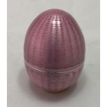 A Russian Faberge silver gilt and pink guilloche enamel egg, in two parts, with plain interior,