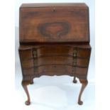 A Queen Anne style walnut bureau, the fall flap opening to reveal a fitted interior, over three long