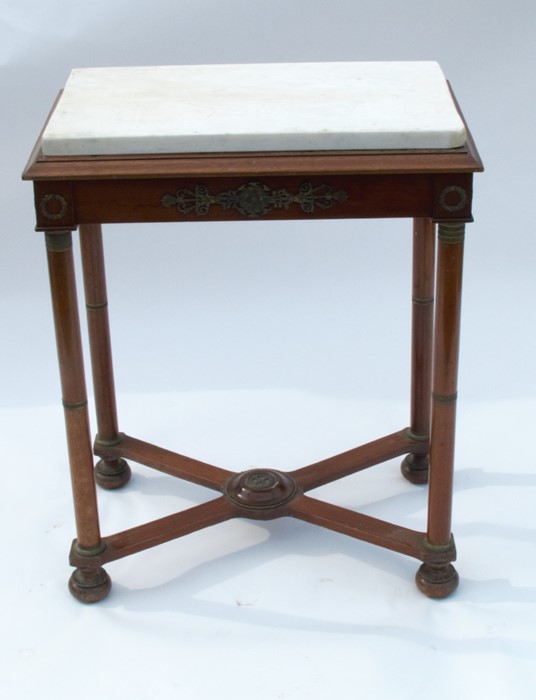 An Empire style marble top centre table, having gilt applied mounts all over, raised on four