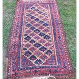 An Eastern rug, decorated with stylised leaves to the field, 53ins x 29ins, together with another