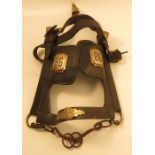 A leather horse harness bridle, with brass bell to the head piece, and sides, brass plaques engraved