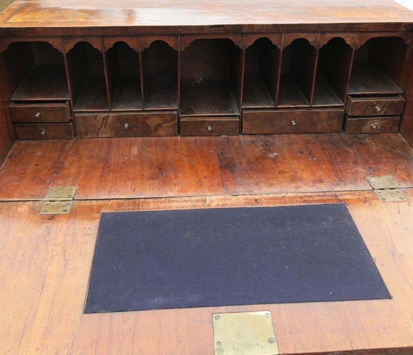 A Georgian walnut bureau, the sloping fall flap opening to reveal pigeonholes and drawers, over four - Image 3 of 3