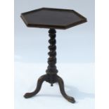 A 19th century mahogany tripod table, having octagonal shaped top, raised on a barley twist column