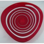 A Whitefriars shallow glass bowl, designed by G Baxter, of oval form, the red body decorated with