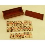 A 19th century miniature bone dominoes set, comprising 28 tiles, in a mahogany box with sliding lid,