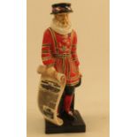 A Royal Doulton figure, modelled as a standing Beefeater holding a copy of The Illustrated London