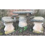 A concrete garden table and three benches, the circular table with three curved bench seats