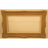 A 20th century picture frame, with decape finish, decorated with scrolls to the shaped rectangular