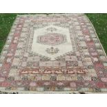 An Eastern rug, decorated in pastel colours to a white ground, 86ins x 66ins