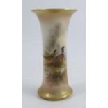 A Royal Worcester spill vase, decorated with a cock and hen pheasant in landscape by Jas Stinton,