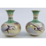 A pair of Royal Worcester Hadley ware vases, of squat form, decorated with Swallows and pine