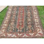 Two Eastern style rugs, the one in browns and blues the other reds and blues, both with holes, 58ins