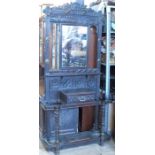 A Victorian carved oak hallstand, with central rectangular mirror, surrounded by hooks with