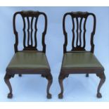 A pair of single mahogany dining chairs, with carving to the top rail, curved supports, drop-in