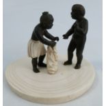 A 19th century carved ivory figure group, of two children with a sack, on a crescent shaped base,