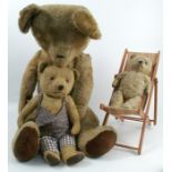 A large gold plush teddy bear, with hump back, height 32ins, together with a dolls deck chair and