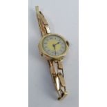 Anonymous, a lady's 9 carat gold mechanical wrist watch, on an expanding baton link bracelet stamped