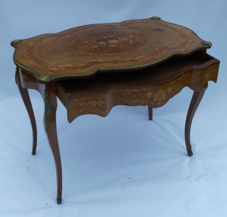 A 19th century style marquetry double serpentine sided centre table, with a central marquetry