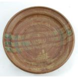 An Art Pottery bowl, of shallow circular form, decorated with a mottled brown and green glaze,