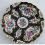 An 19th century Worcester porcelain plate, with scale blue ground and reserves decorated with