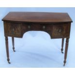 A 19th century mahogany bow front sideboard, fitted with three drawers, raised on reeded front