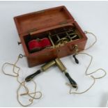 A mahogany cased electric shock machine, with ebonised handles and brass mechanism, box size 10ins x