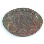 An oval polished fossilised stone plate, diameter 13ins