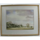 A 20th century English watercolour, view across a field to church and houses, 13ins x 18ins