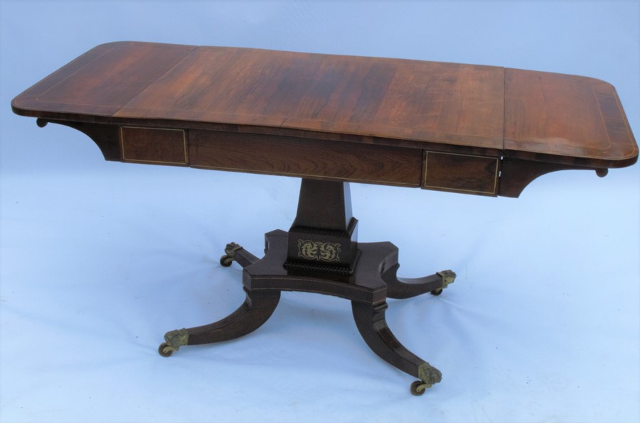 A 19th century rosewood sofa table, with drop flaps, satinwood inlay, fitted with one frieze drawer,