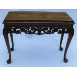 A 19th century mahogany and walnut console table, of rectangular form, the carved frieze decorated