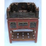 An Eastern painted side table, the top having three sides carved and decorated with Oriental scenes,