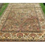 A pair of Eastern style rugs, decorated with leaves and flowers to a gold ground, 74ins x 108ins