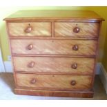 A Victorian satin birch chest of drawers, fitted with two short over three long drawers, raised on a