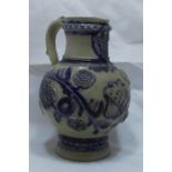 A 19th century German Westerwald pottery jug, decorated in the typical palette with an applied