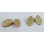 A pair of 9 carat gold cufflinks, the oval panels, one plain, one engine turned, with chain link