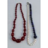 A 'half and half' lapis lazuli and freshwater pearl necklace, together with a row of simulated amber