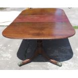 A Regency style D end dining table, with one leaf, raised on two turned columns with reeded outswept