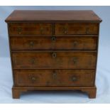 A 19th century walnut chest, fitted with two short over three long, graduated drawers with cross