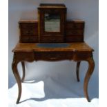 A 19th century walnut ladies writing desk, the central mirror door cupboard over a drawer, flanked