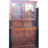 An Edwardian mahogany cabinet, the upper section having a pair of glazed doors on turned columns,
