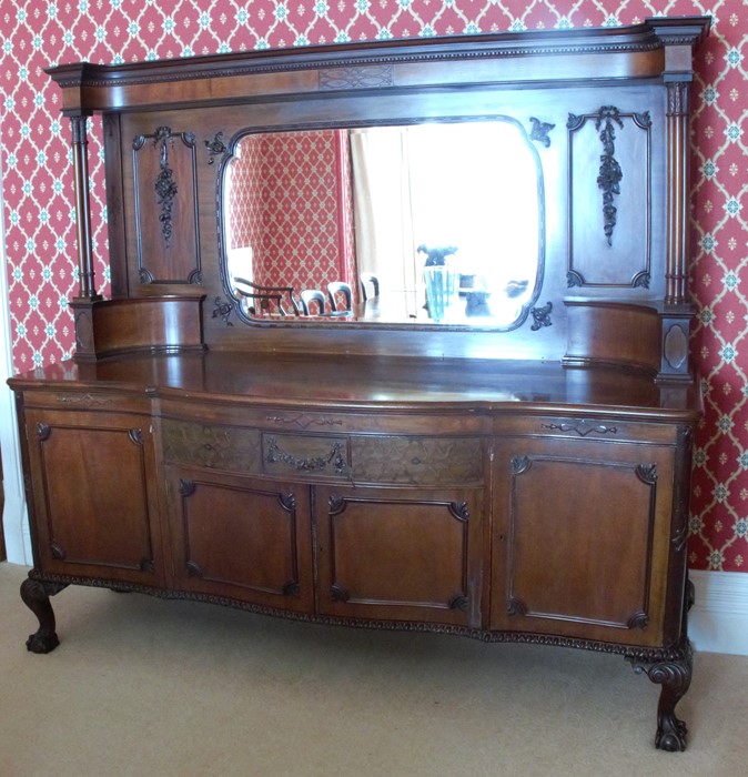 A late 19th century mahogany mirror back sideboard, with bow front, the mirror back with carved