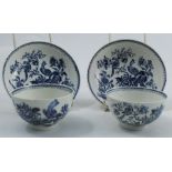 Two 19th century English porcelain tea bowls and saucers, decorated in a blue and white version of