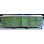 A large Victorian painted pine dresser base, the green base fitted with a pair of cupboard doors