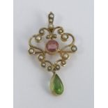 An Edwardian pink tourmaline, peridot and seed pearl pendant brooch, stamped '15ct', with detachable