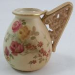 A Royal Worcester blush ivory vase, decorated with flowers, having a pierced angular handle, shape