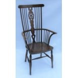 A 19th century ash, elm and fruitwood high comb back Windsor armchair, with shaped, pierced splat