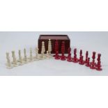 An Antique carved bone chess set, stained red and natural, thirty-two pieces, height of king 2.